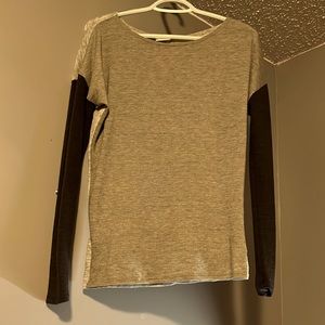 this is a a grey light weight long sleeve shirt with a ripped back in the shirt